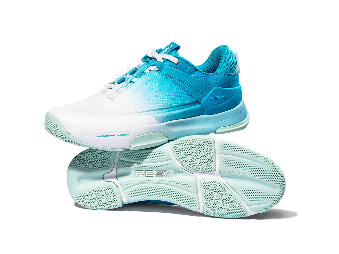 Pair of women's Court2 pickleball shoes in a blue and white gradient design with non-marking soles