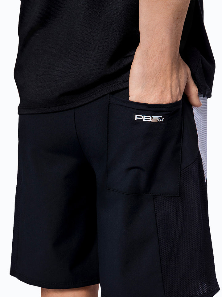 Man lifting shirt to reveal the back waistband of PB5star Vented Court Shorts with a focus on the utility pocket.