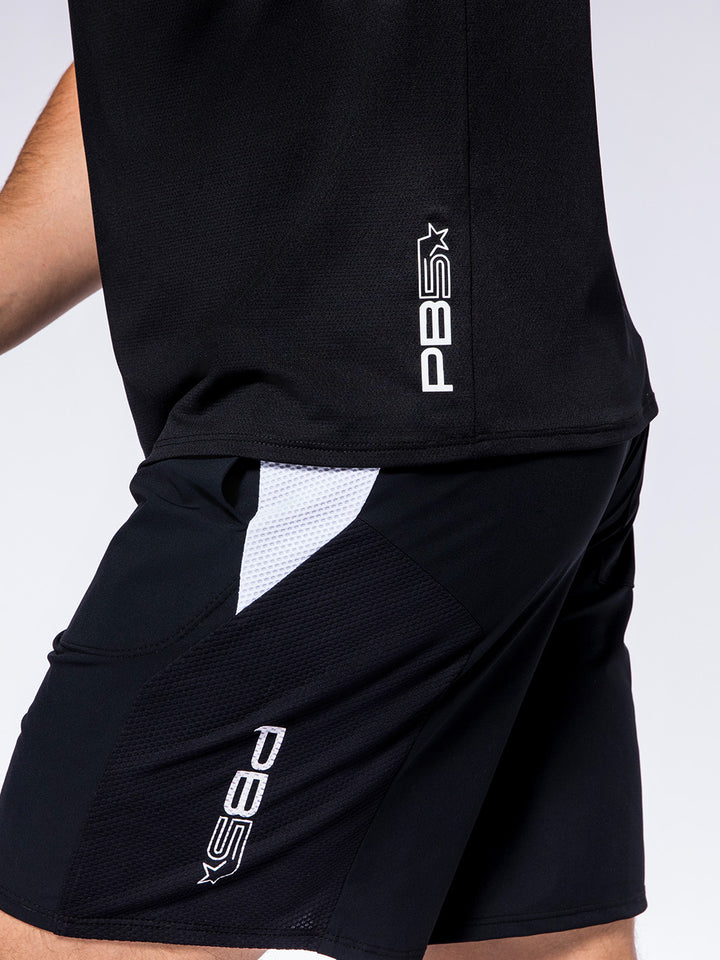 Close-up of PB5star Vented Court Shorts in black, featuring white mesh panel for breathability during sports activities.