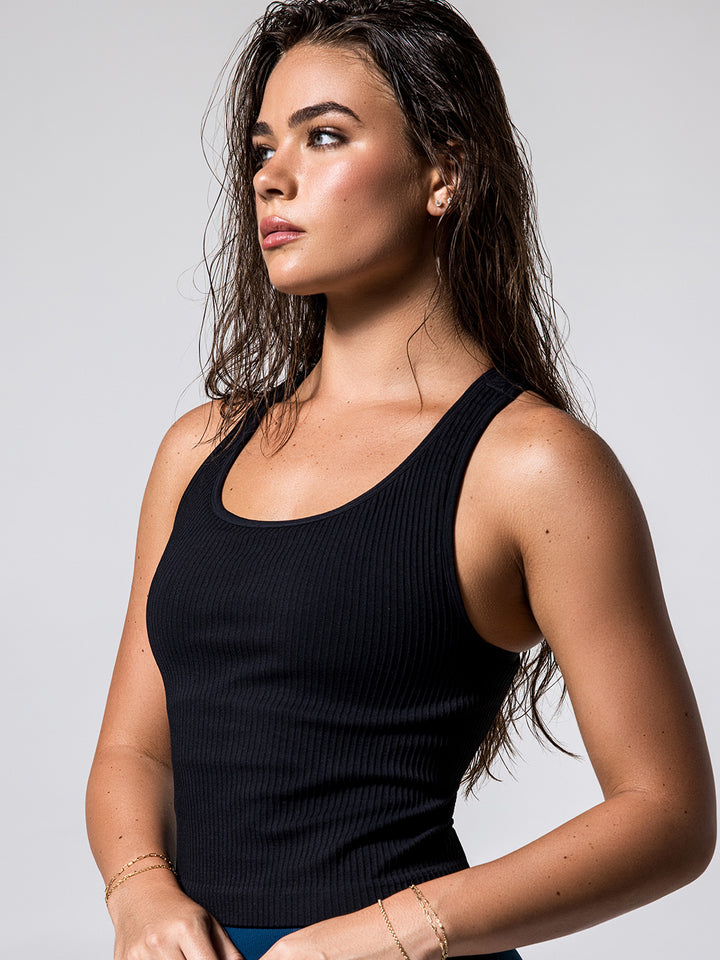 Close-up of woman wearing black Ribbed Racer Back Tank.