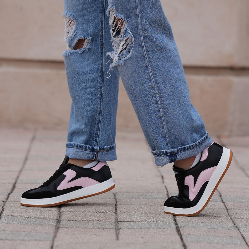 Model walking in PB5star Cosmic sneakers in black and pink with jeans, casual street style lifestyle view
