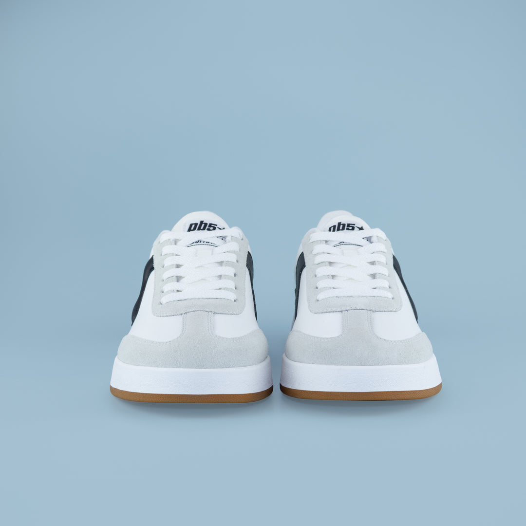 Front view of PB5STAR Cosmic sneakers in white, black, and grey with gum soles, displayed on a light blue background.