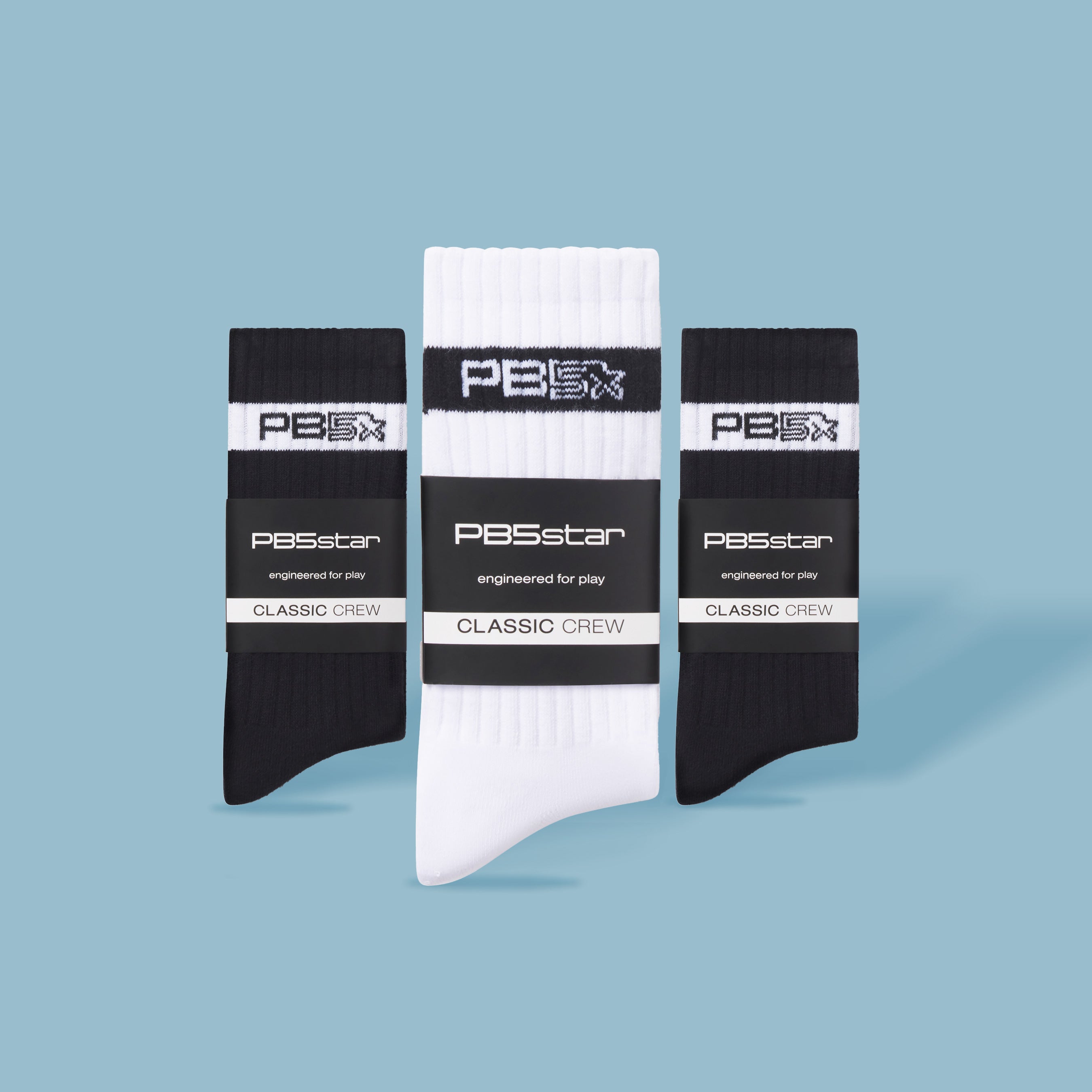 Line up of three  pairs of PB5star classic crew socks in black and white.