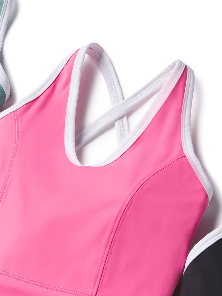 Close-up of a pink PB5star side split court dress with white trim and crisscross straps, highlighting the sleek and supportive design. Perfect for active play on the pickleball court.