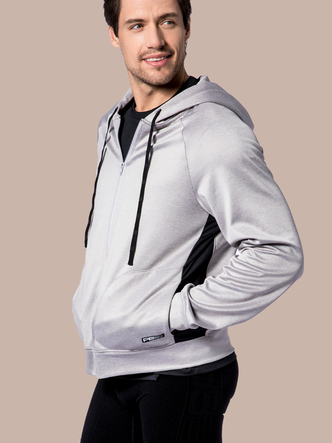 Side profile of a male model in a PB5star grey heather Performance Full Zip Hoodie with black details.