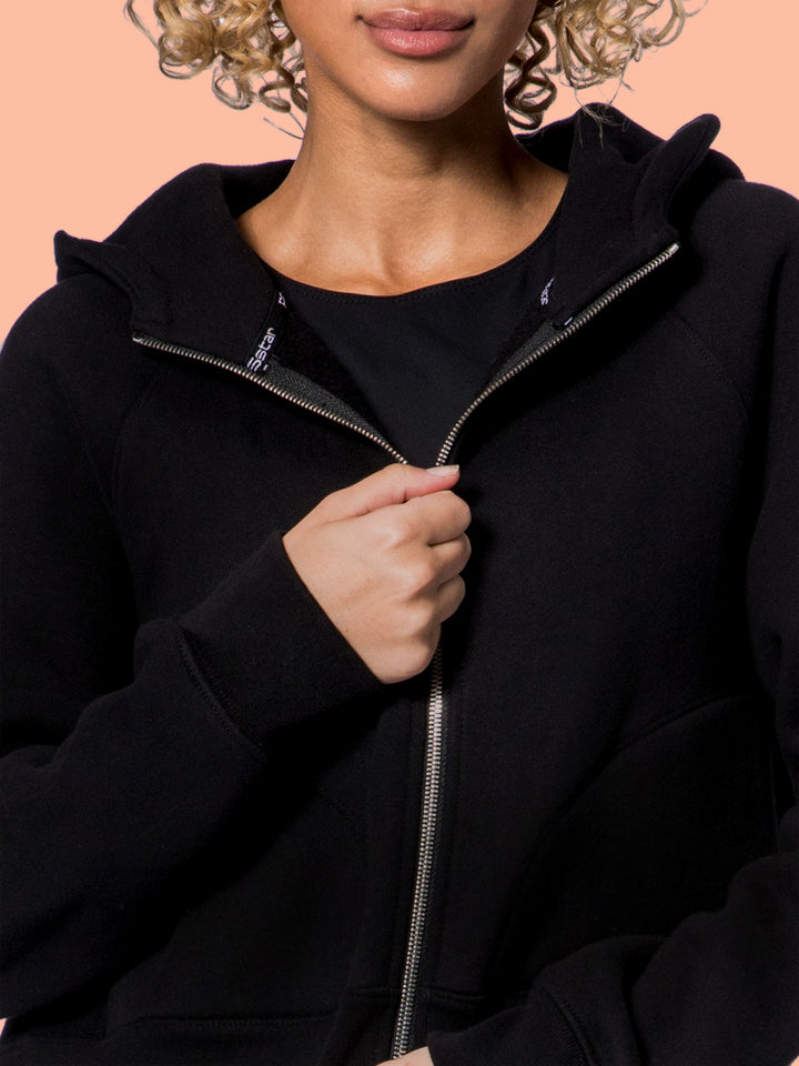 Close-up of a model wearing the PB5Star Luxe Cropped Lounge Hoodie, showcasing the cozy black fabric and stylish design.