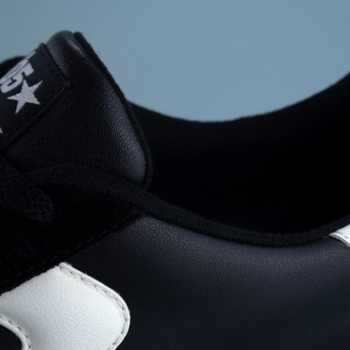 Close-up collar and side panel detail of PB5star men’s Cosmic pickleball court shoe in black and white leather.