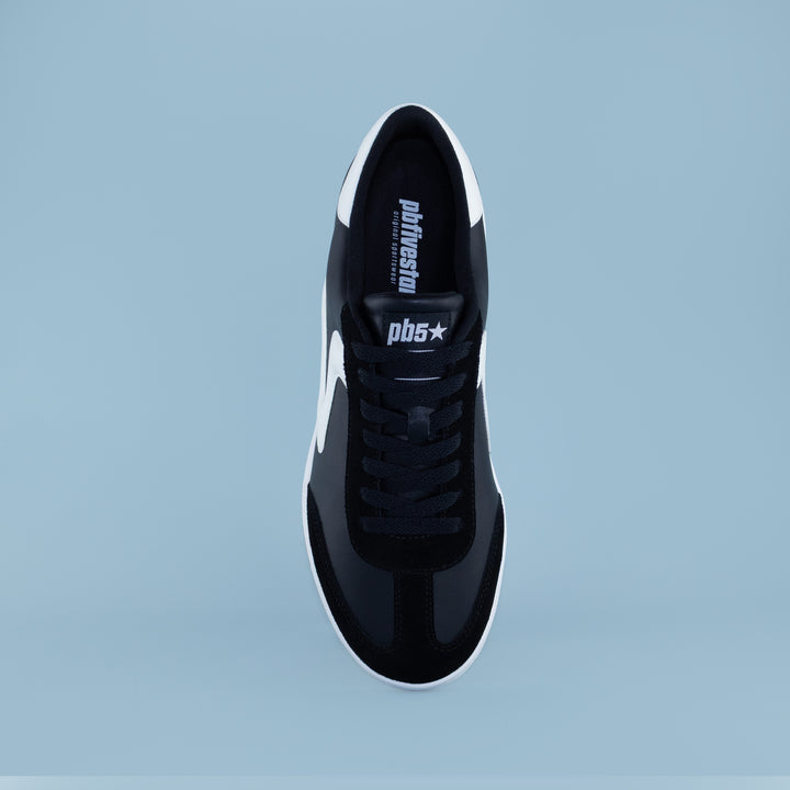Top view of PB5star men’s Cosmic sneaker in black and white, showcasing lacing, suede detail, and logo tongue.