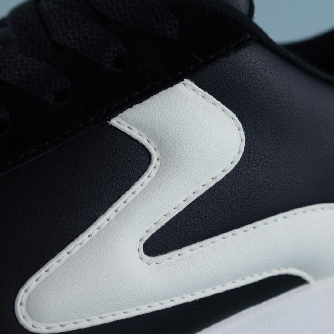 Side detail of PB5star men’s Cosmic pickleball court shoe in black and white — premium athletic shoe material close-up.