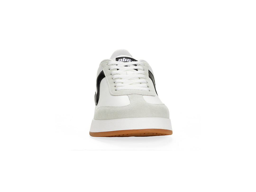 Front view of a white and black low-top sneaker with gum sole.