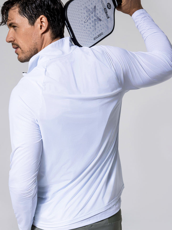 Man wearing white M's Long Sleeve Layering Tee holding a PB5star Control pickleball paddle over his shoulder, facing away from the camera.