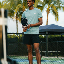 Male pickleball player wearing head to toe PB5star from Instagram post. Palm trees in background.