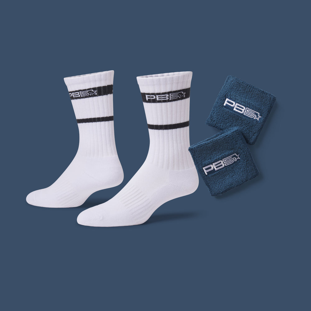 PB5star white athletic crew socks and navy sweat wristbands with logo branding on blue background, pickleball performance accessories