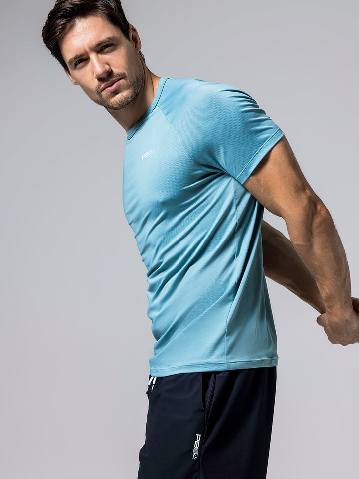 Man stretching in Arctic Core Performance Tee and black Signature Court Shorts against light gray background.