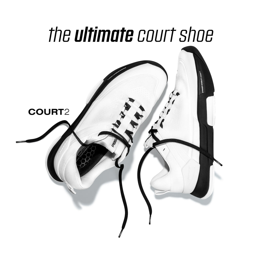 Top-down product shot of white-and-black COURT2 sneakers with loose laces, headline: ‘the ultimate court shoe