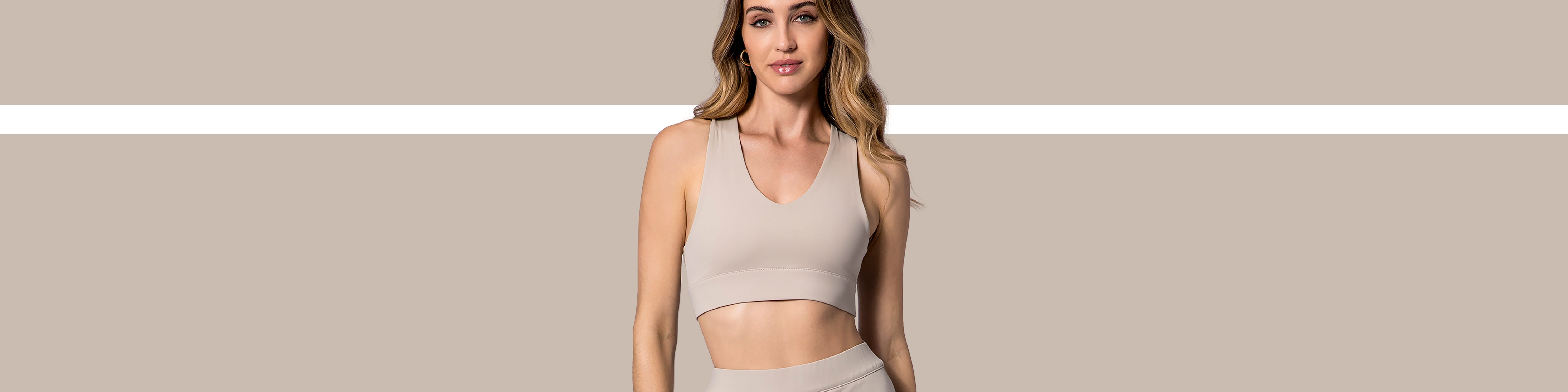 Close-up on model wearing a X-Over Back Sports Bra in soft clay.