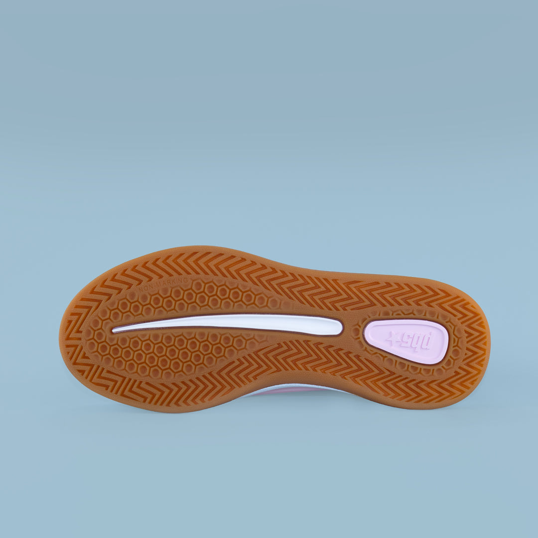 Outsole view of women’s Cosmic pink and black sneaker with gum tread, dual-density hex and herringbone grip.