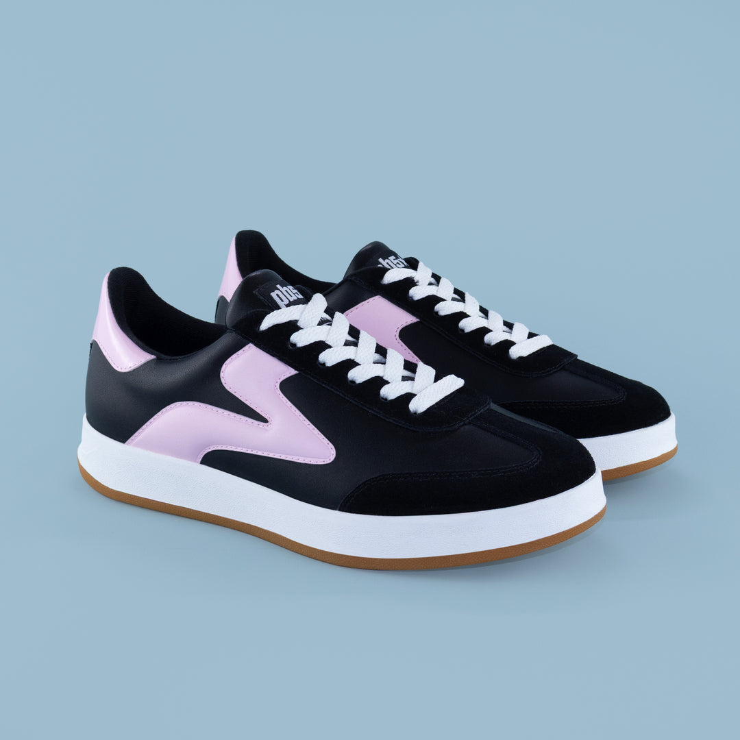Pair of women’s black and pink Cosmic sneakers with white laces, ideal for pickleball, court wear, and athletic outfits.