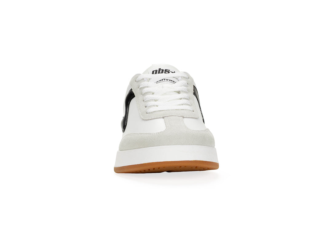 Front view of a white and black low-top sneaker with gum sole