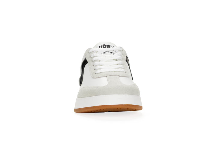 Front view of a white and black low-top sneaker with gum sole
