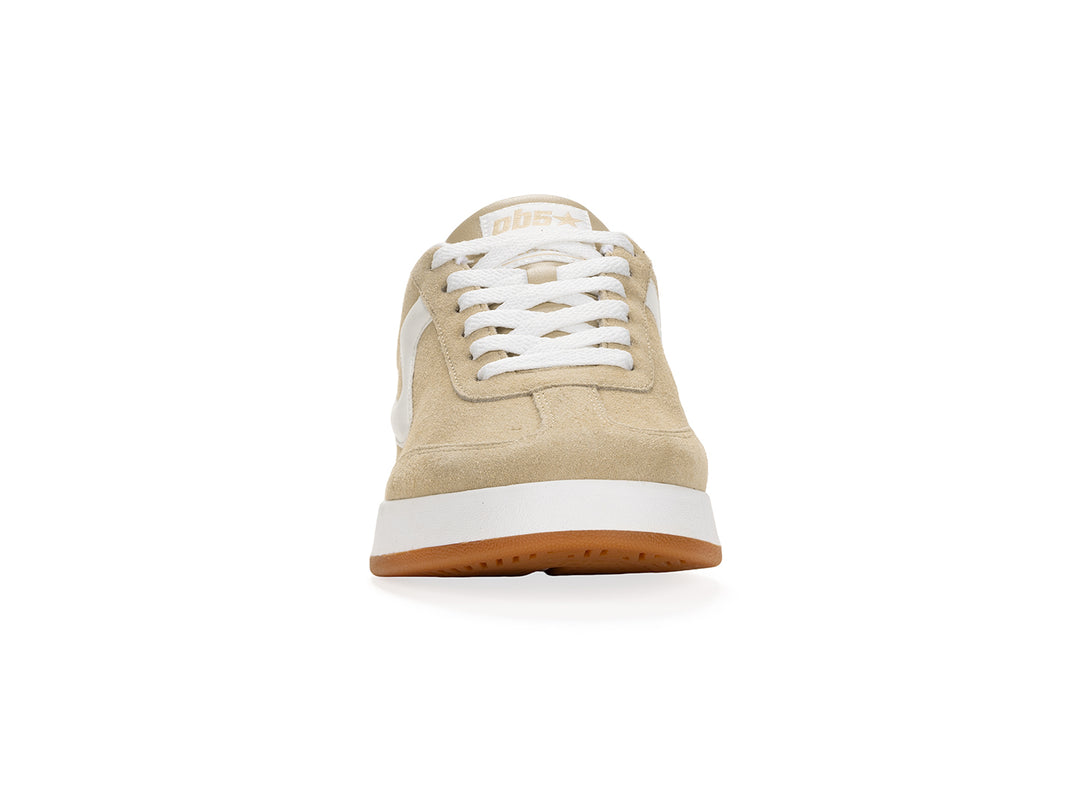 Front view of a sand and white low-top sneaker with gum sole