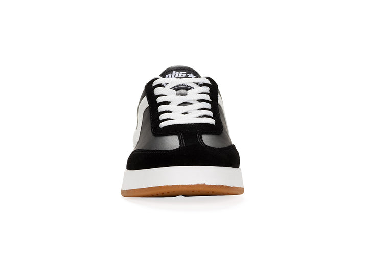 Front view of a black and white low-top sneaker with gum sole