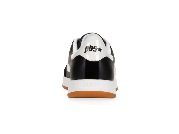 Rear view of a black and white low-top sneaker with gum sole