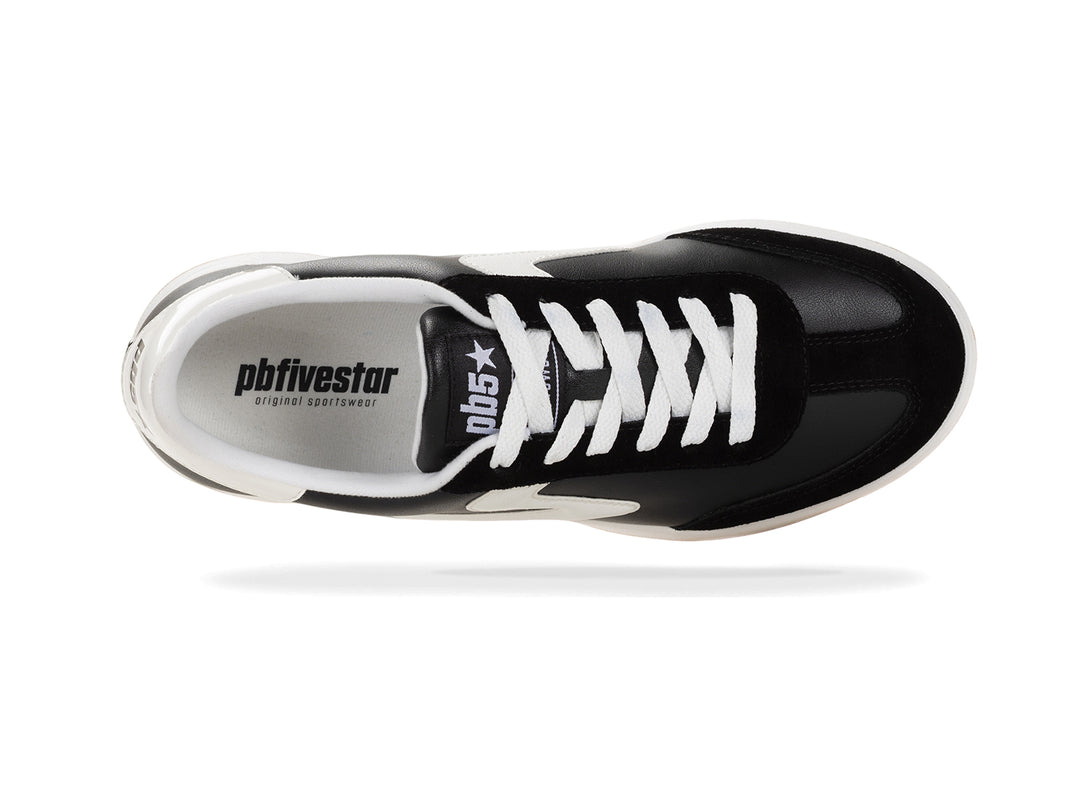 Top view of a black and white low-top sneaker with white laces