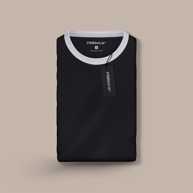 Folded black PB5star Core Tank with contrasting white collar detail and branded tag, presented on a beige background, symbolizing premium sports fashion.