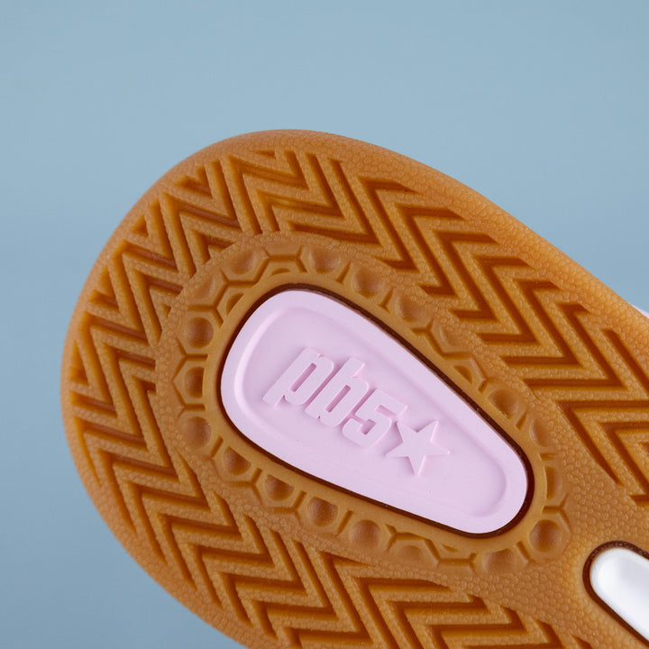 Close-up of a textured shoe sole with a pink PB5star logo on a light blue background