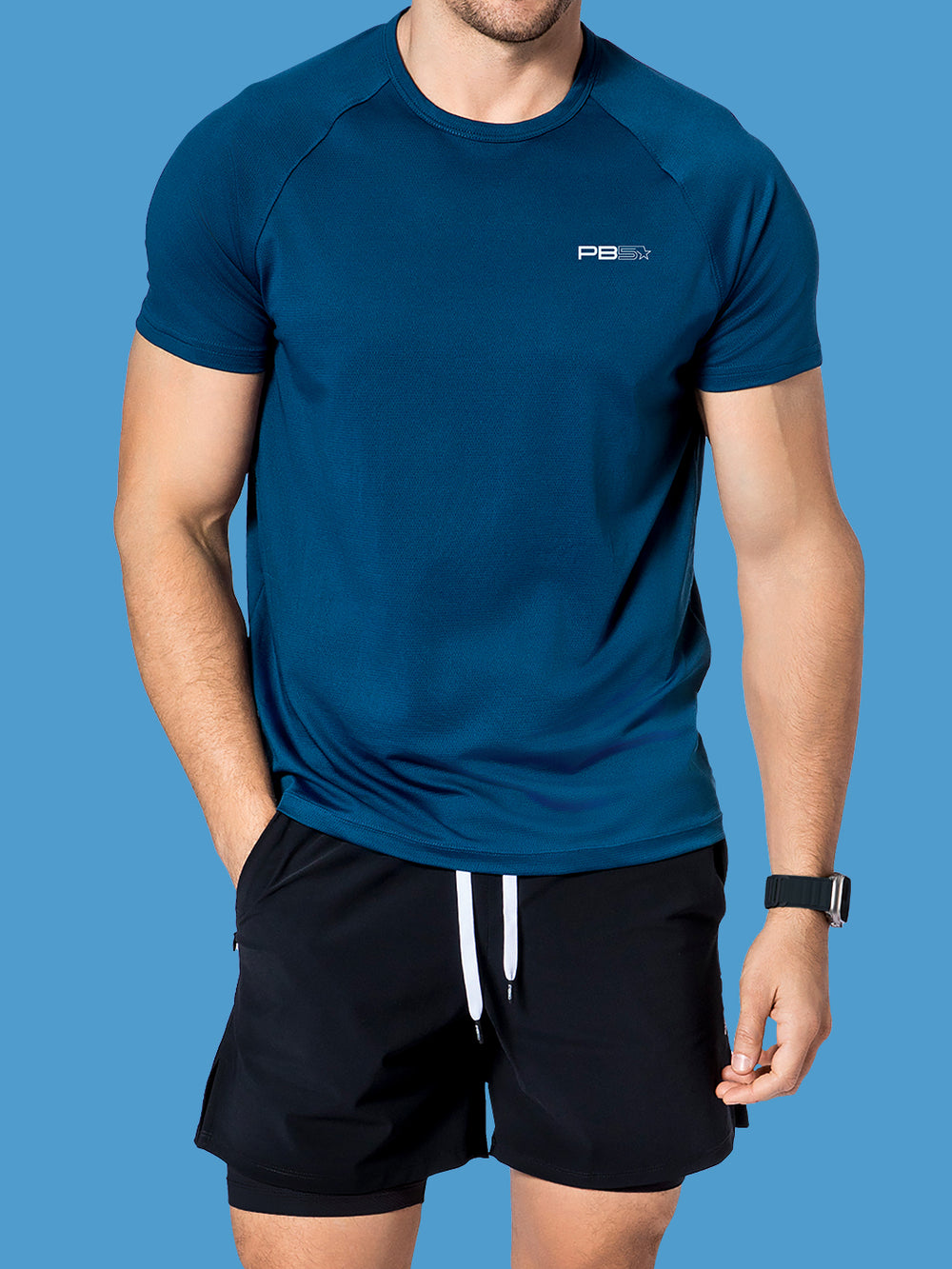 Athletic male in a PB5star astral blue Performance Tee and versatile black Signature Court Shorts for a functional and stylish workout outfit.