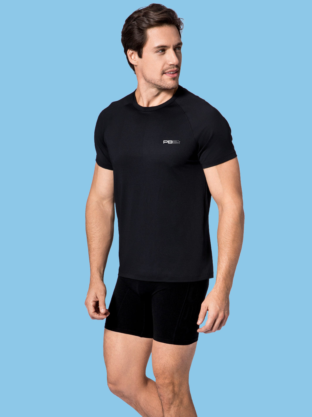 Man in black PB5star Core Performance Tee and compression shorts, designed for style and pickleball play.