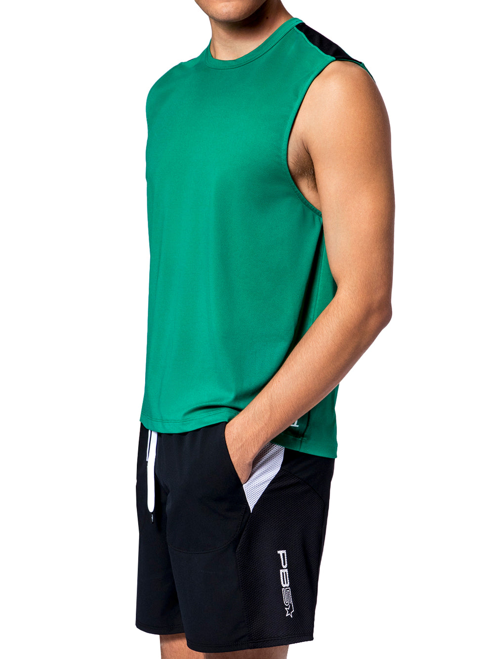 Model in men's jade Vented Sleeveless Tee and PB5star black Vented Court Shorts with hand in pocket, showcasing the sporty design.