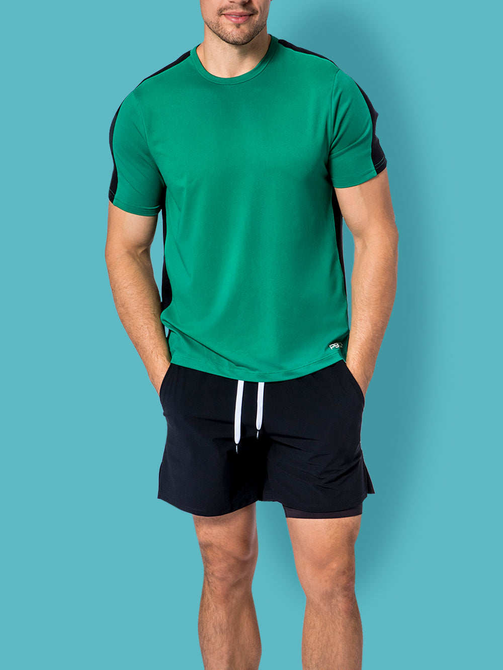Man in PB5star black Signature Court Shorts and jade Performance Tee, ready for peak performance in any sport.